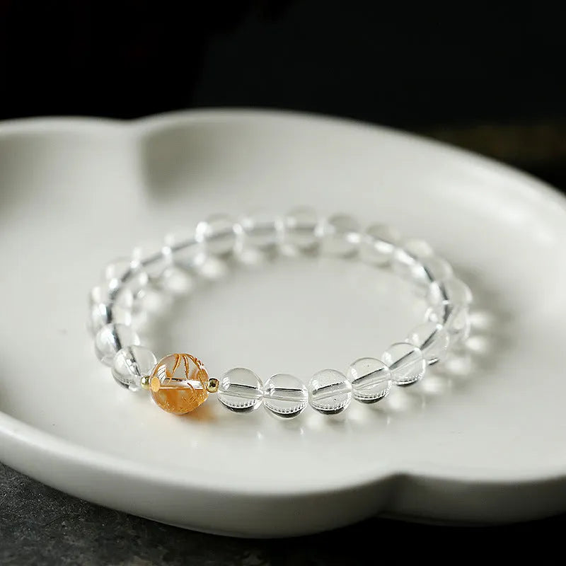 Geometric obsidian black agate white crystal bead bracelet with gold dragon charm on wrist