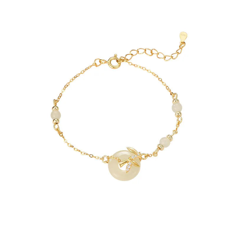 Women's antique style Hetian Jade bracelet with a silver safety buckle on a wrist.