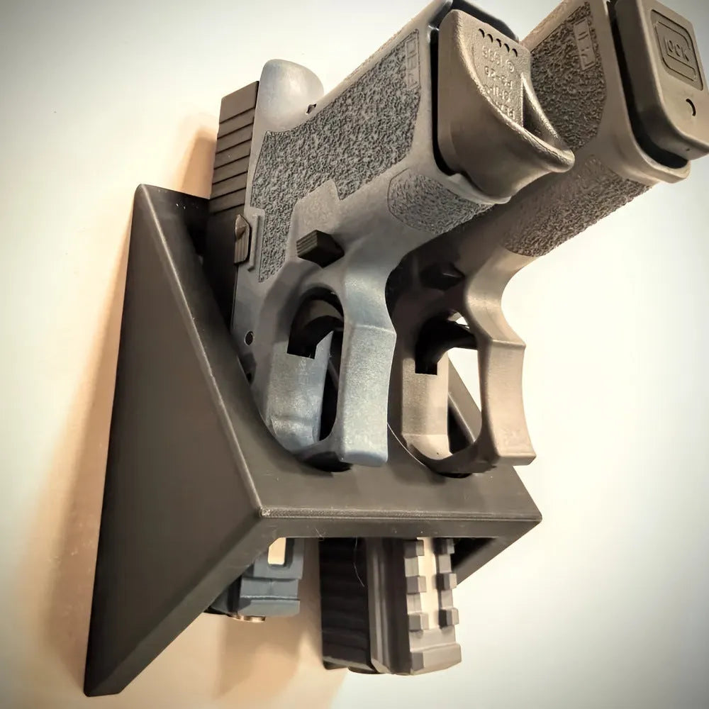 Black plastic pistol display stand with punk-style design measuring 10.85 by 7.6 centimetres