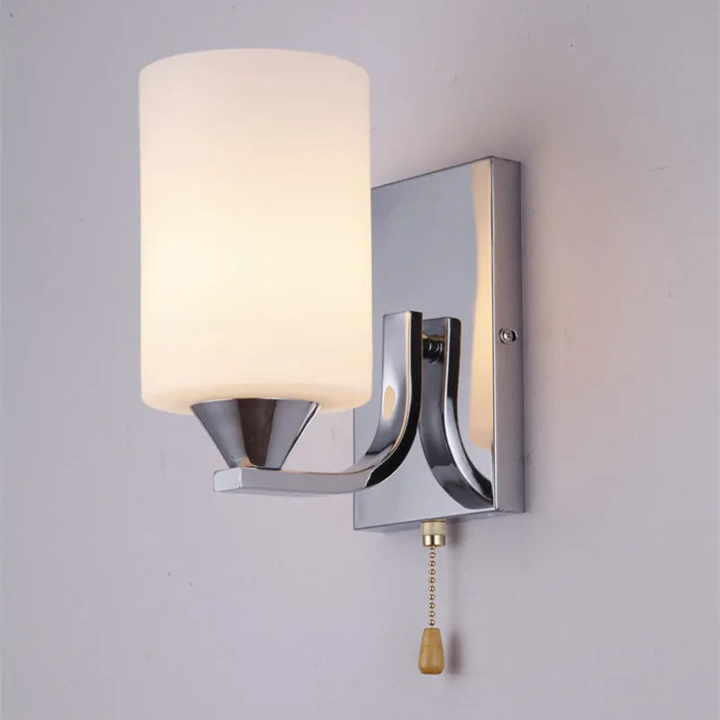 Chrome-finished glass wall lamp with minimalist design mounted on wall