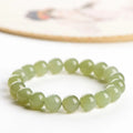 Polished Hetian jade ball bracelet showing spherical beads in ice-like clear water colour on a wrist.