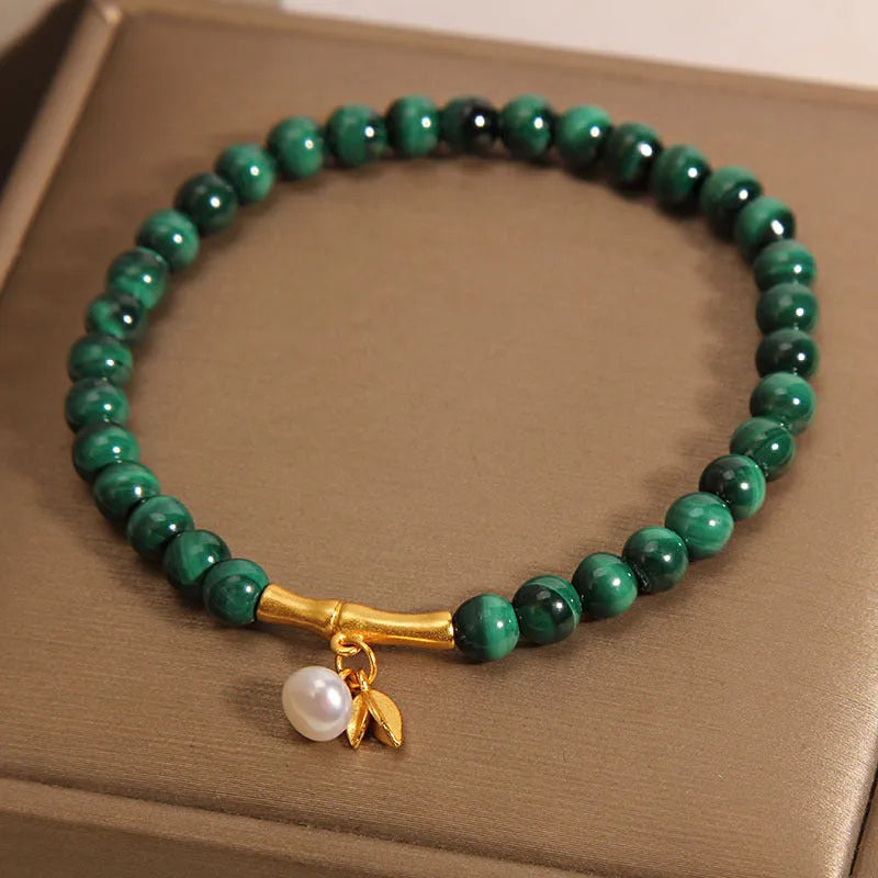 Women's adjustable bamboo bracelet with white crystal elements on a wrist.