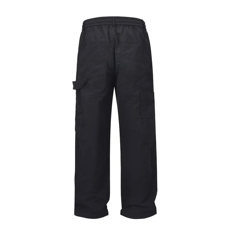 Black baggy paratrooper trousers with elastic drawstring waist and three-dimensional cutting