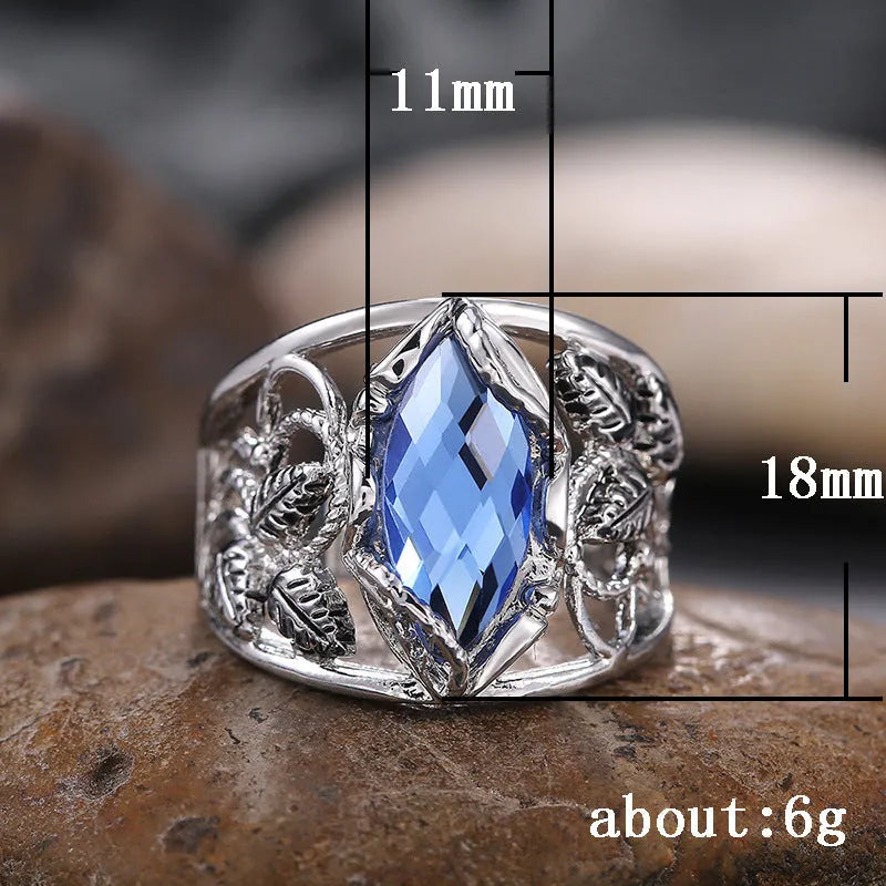 Blue horse eye-shaped crystal ring for women on a hand, showing geometric alloy design.