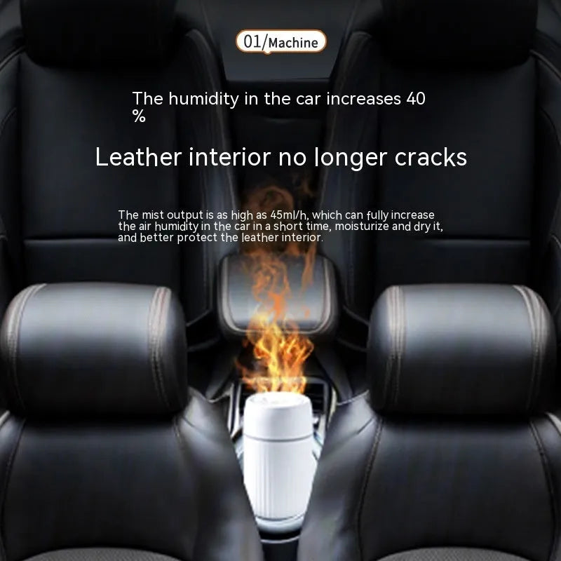 Black car aroma diffuser with simulation flame on a dashboard next to a cup holder.