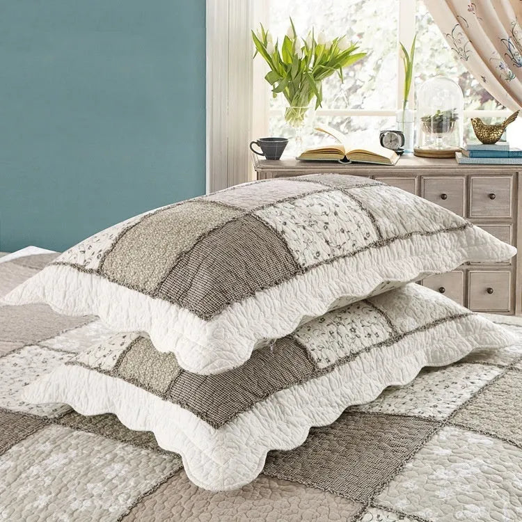 Washed pure cotton quilted bedspread and pillowcases three-piece bedding set on a bed.