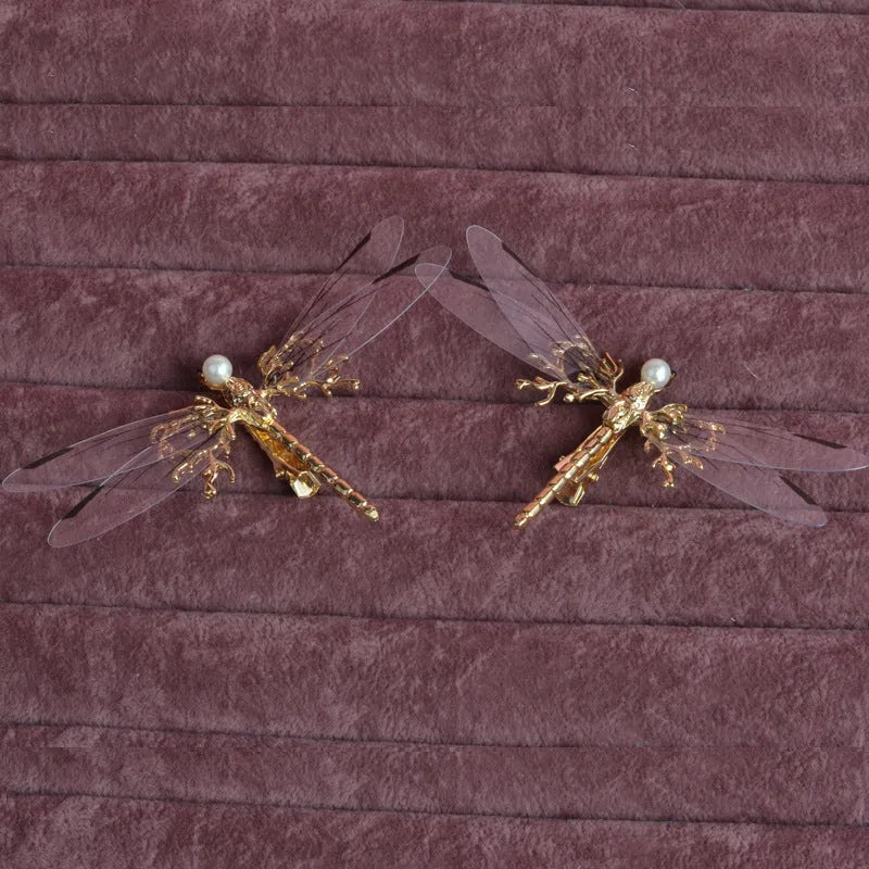 Gold-coloured dragonfly headdress with side clip fastening and floral decorative elements