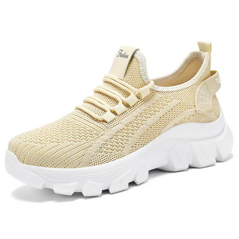 Women's white Flyknit sneaker with thick PVC sole and lace-up closure on a neutral background.