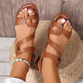 Women's flat sandals with Velcro straps in black, brown, and colourful options on a rubber sole.
