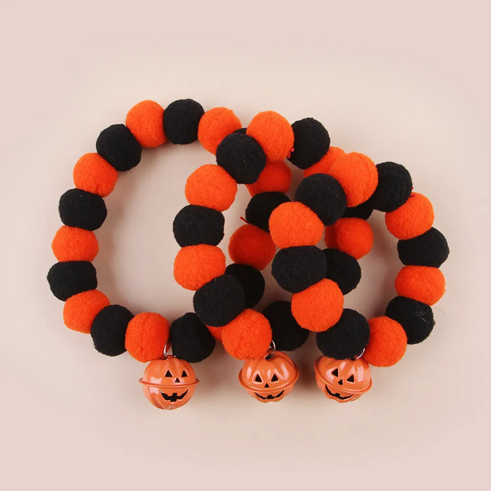 Black, orange, green, and purple Halloween pumpkin cat collar with adjustable strap.
