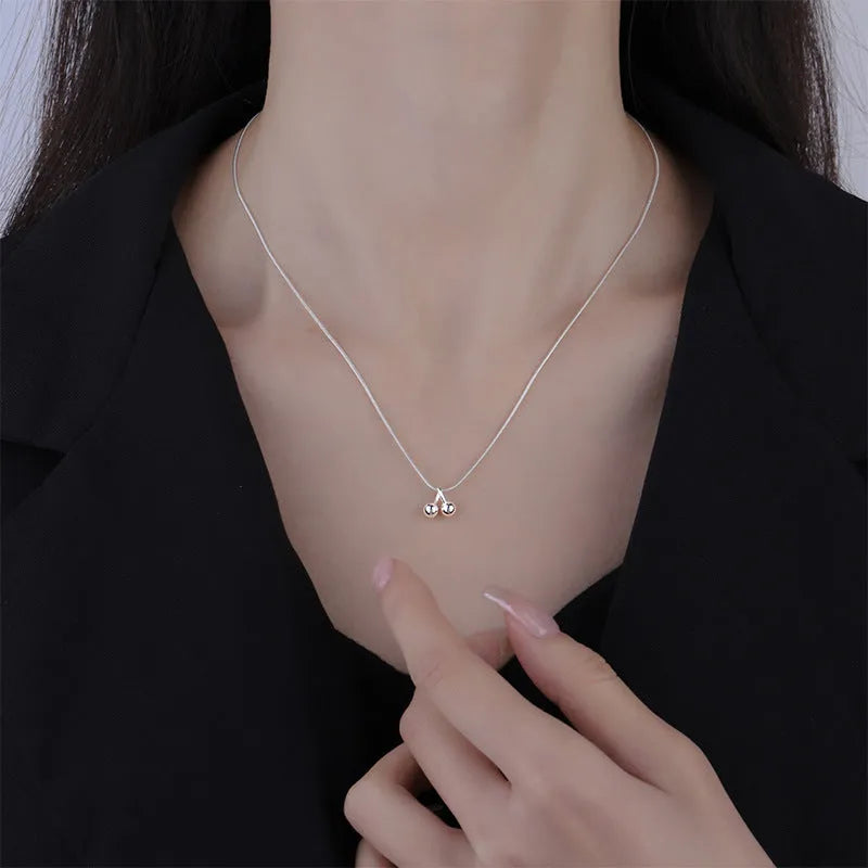 Silver cherry pendant necklace on a snake bone chain, adjustable from 21cm to 50cm.