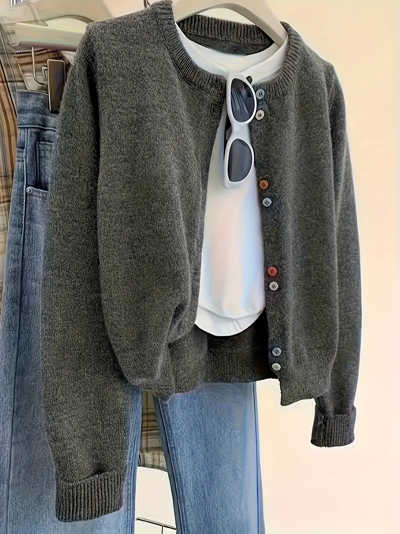 Dark grey solid colour women's cardigan with button front and long sleeves.