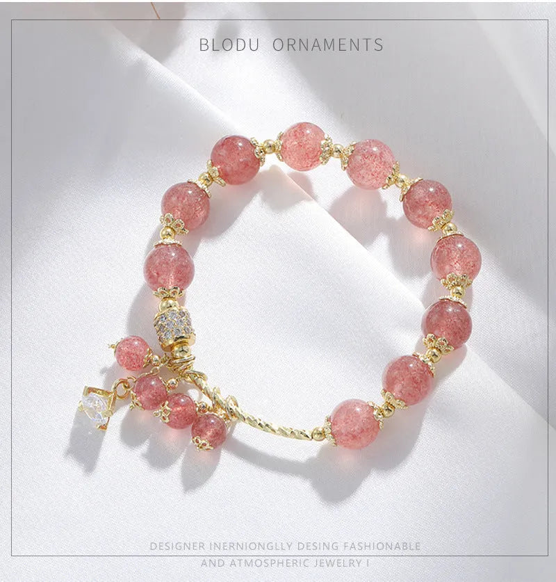 Pink women's crystal bracelet with heart-shaped charms and pearl decorative accents
