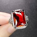 Women's geometric ring with pigeons-blood ruby in adjustable platinum colours