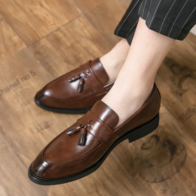 Men's black slip-on business casual shoes with tassel detail and rubber sole