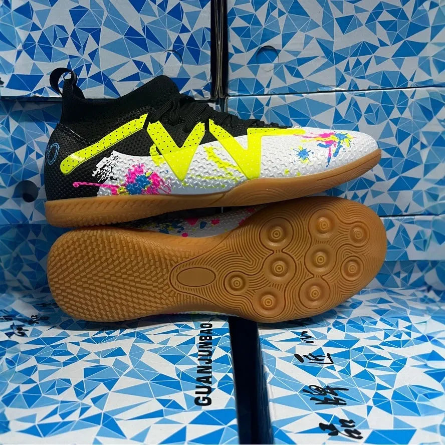 Low-top soccer shoes in black and yellow colour with a PVC upper and rubber studded outsole.