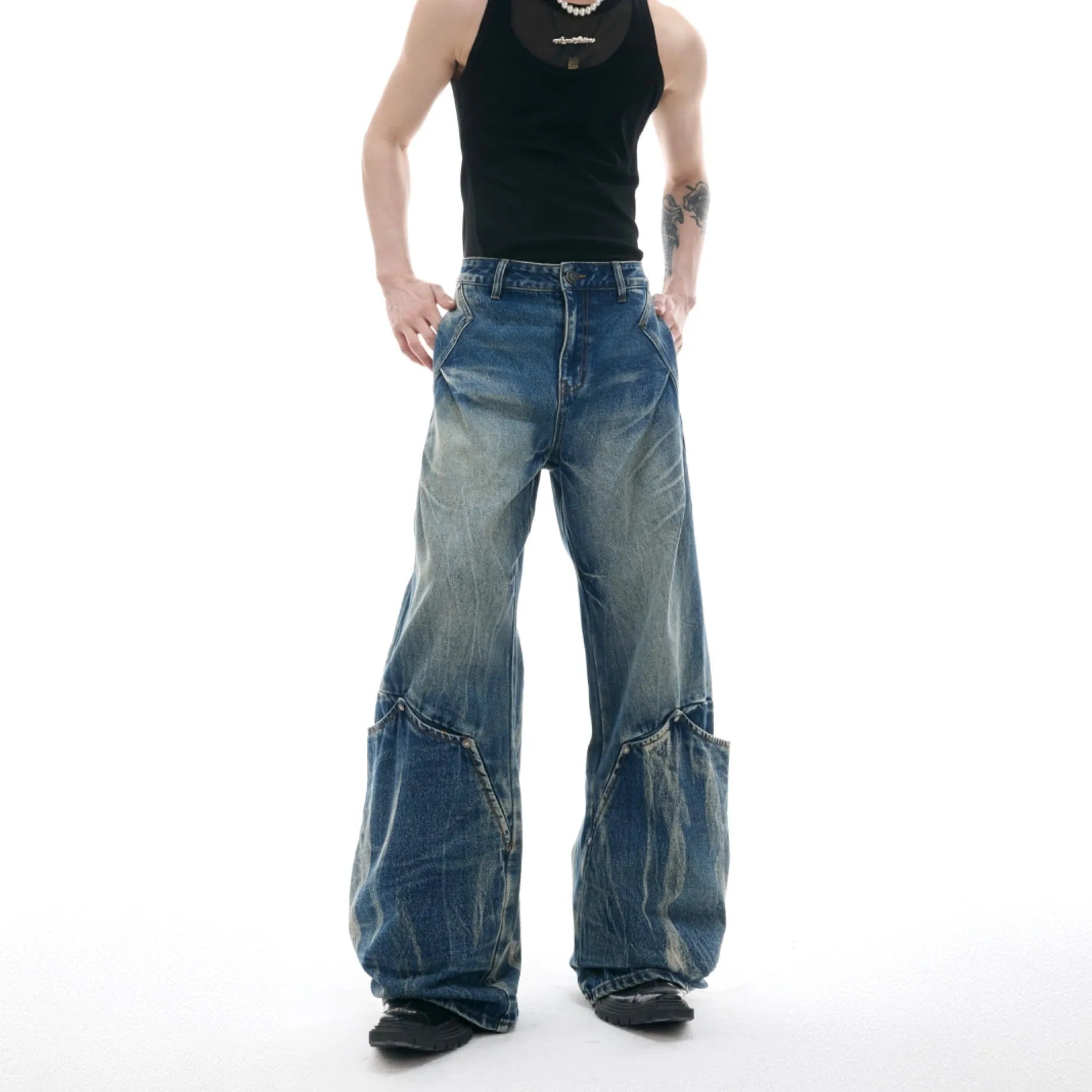 Men's verdant blue retro jeans with washed burst pattern showing curved knife fit and loose silhouette