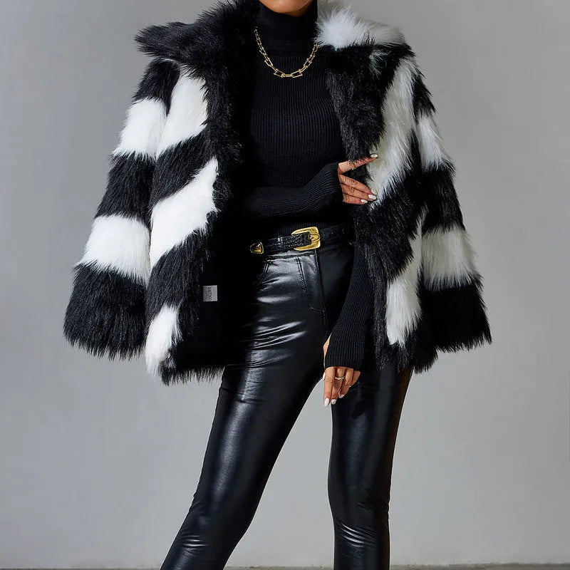 Women's beige faux fur lapel coat with a dark contrast fur collar on a hanger.