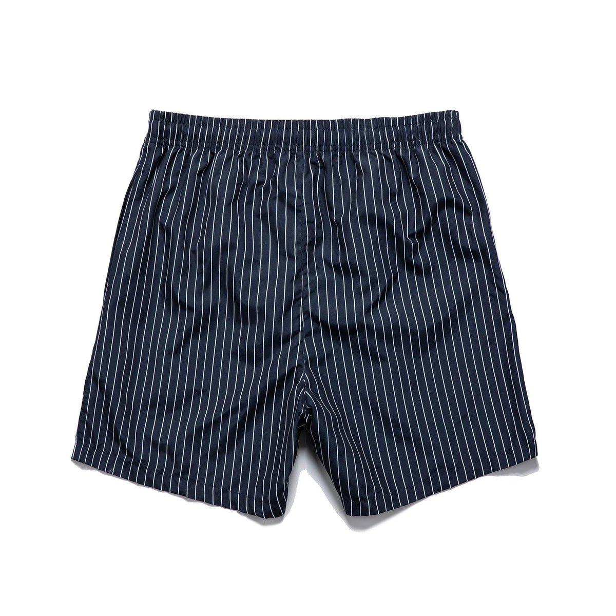 Man or woman wearing striped polyester shorts in navy blue, straight leg style, for beachwear.