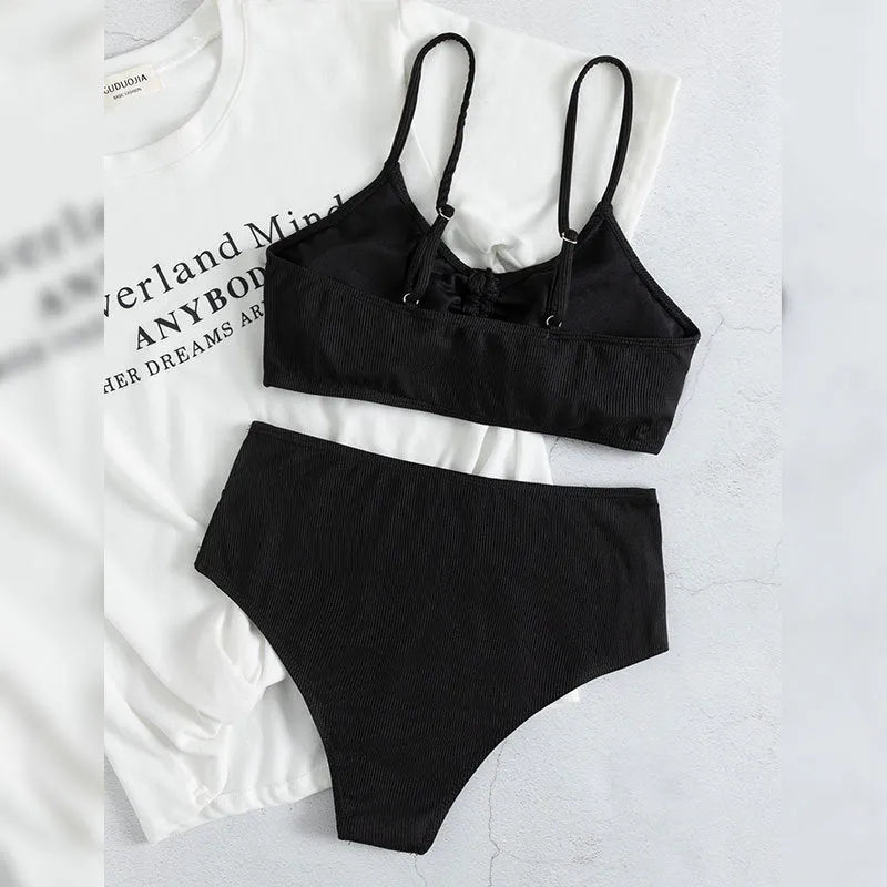 Black women's bikini swimsuit with high-waist shorts and sling split design.