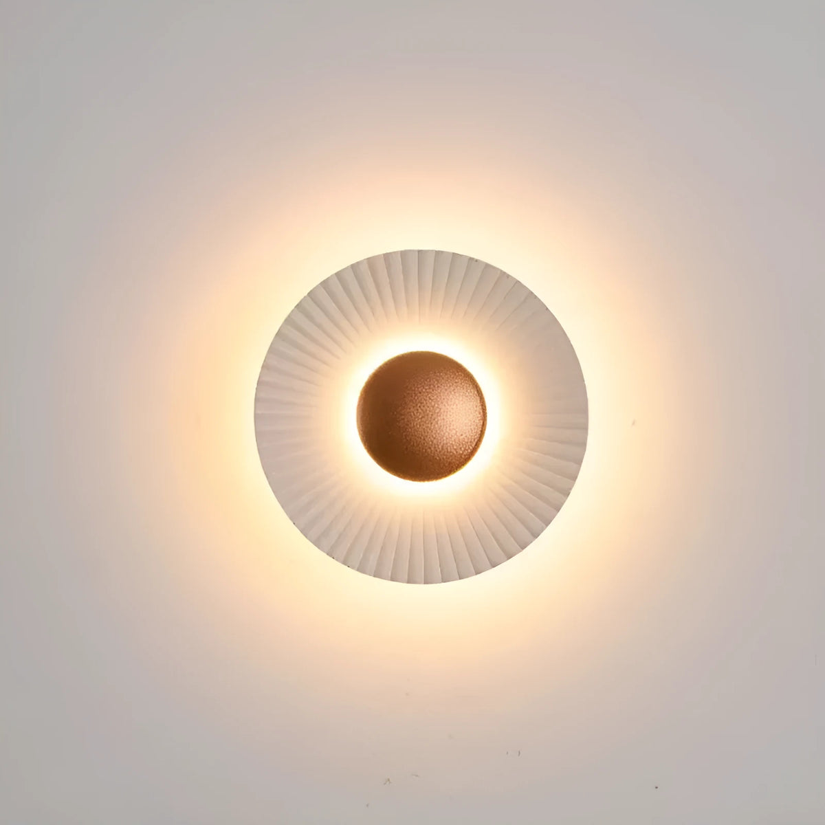 Round aluminium wall lamp with white and gold colour options mounted on wall