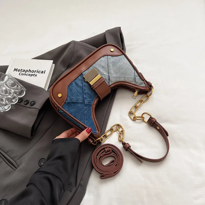 Brown denim women's bucket shoulder bag with chain strap and diamond mesh detail.