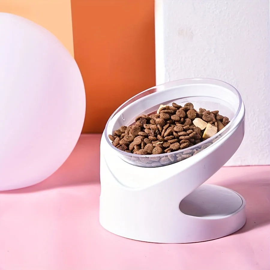 Clear plastic tilted cat food bowl for ergonomic feeding and neck protection