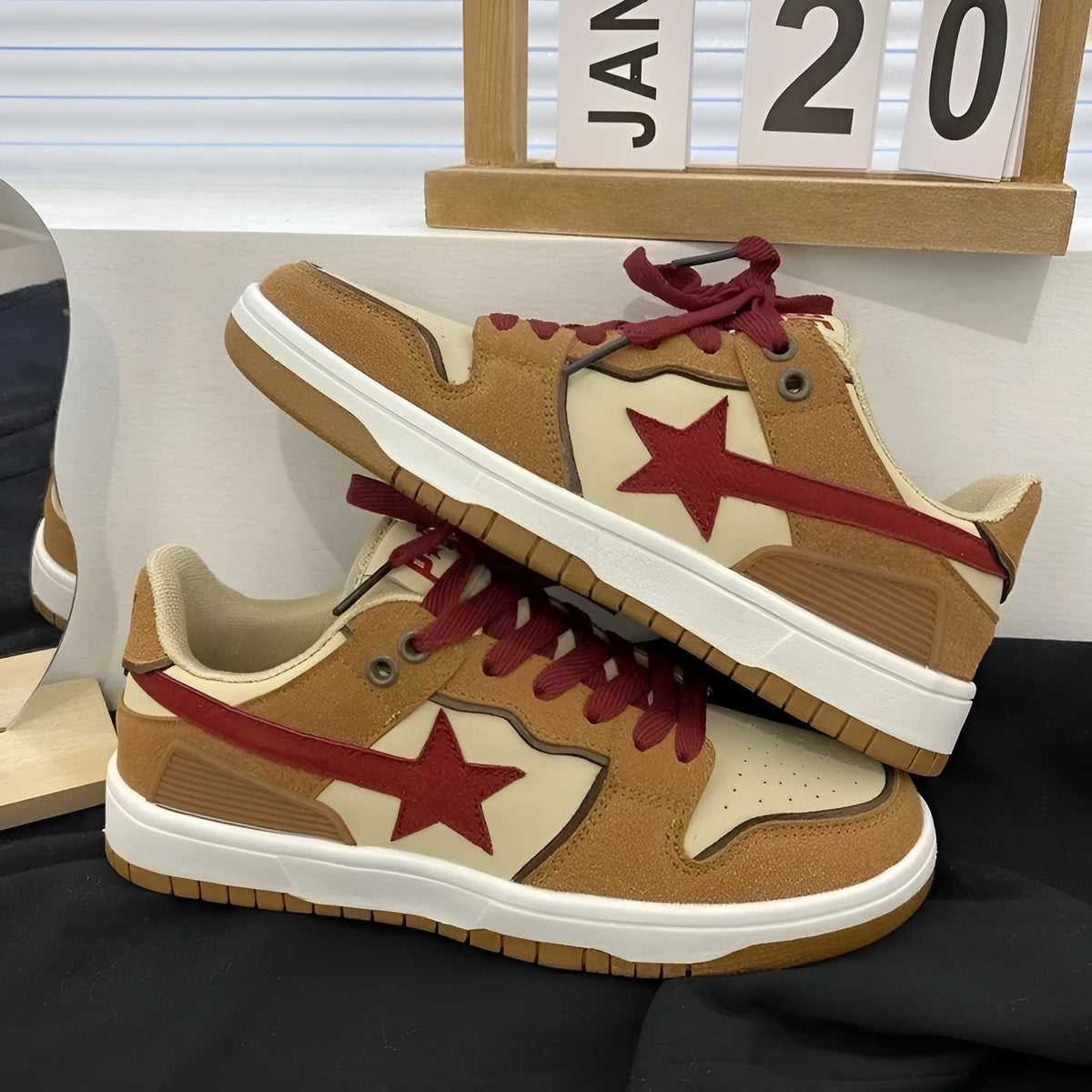 Brown women's low-top sneakers with sequin trim and platform heel on rubber sole.