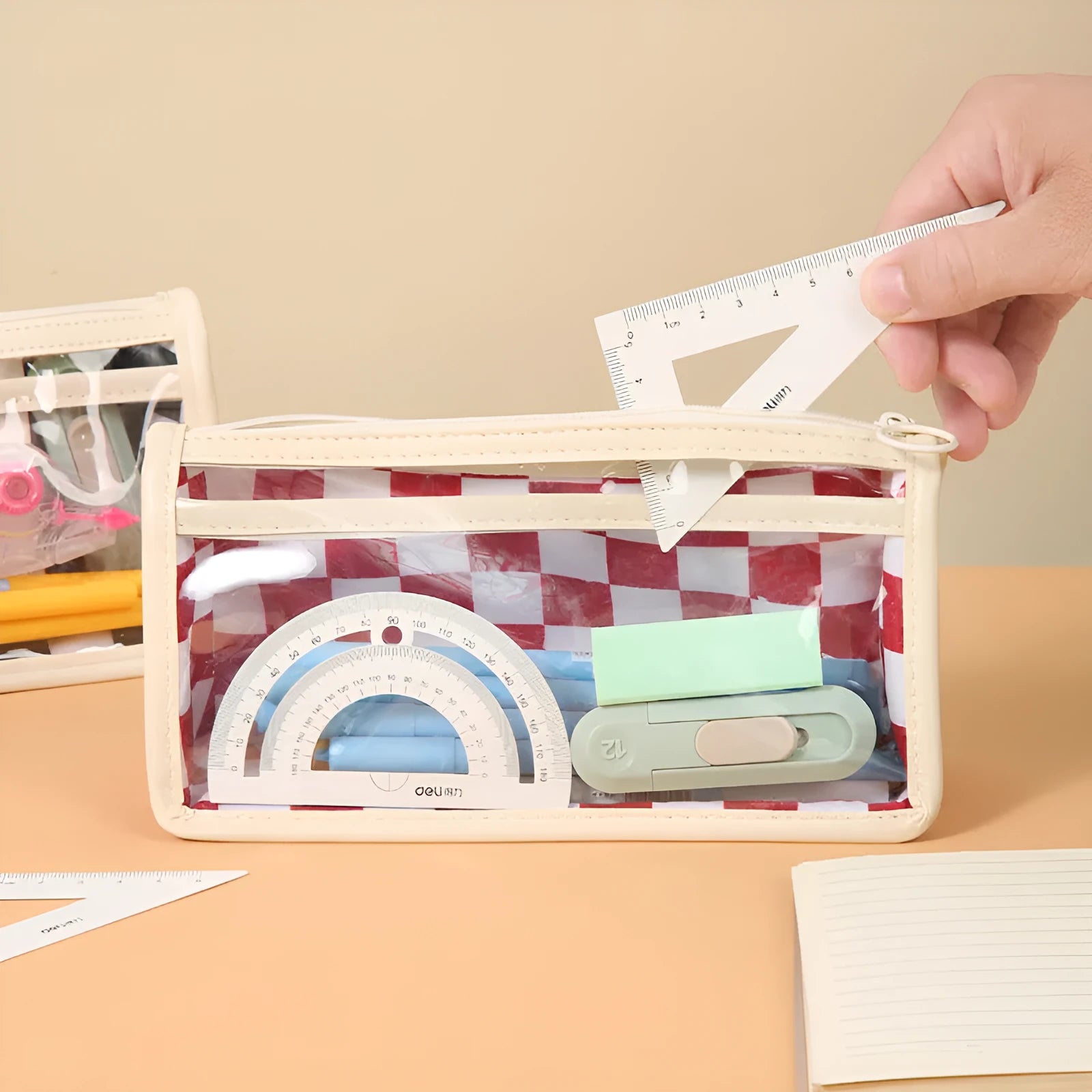 Transparent chessboard pattern PVC pencil case showing pens inside, black and white grid design