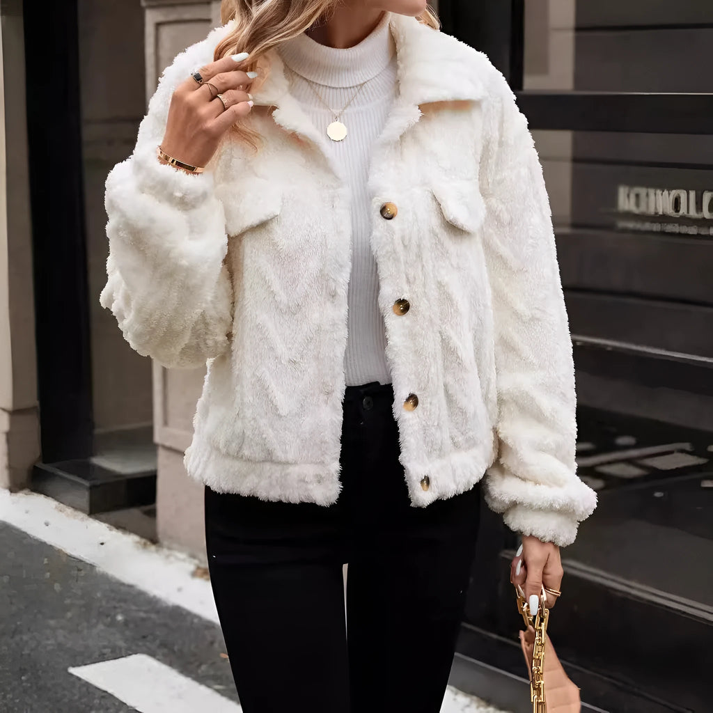 Ivory white women's double-sided plush button cardigan on a hanger.