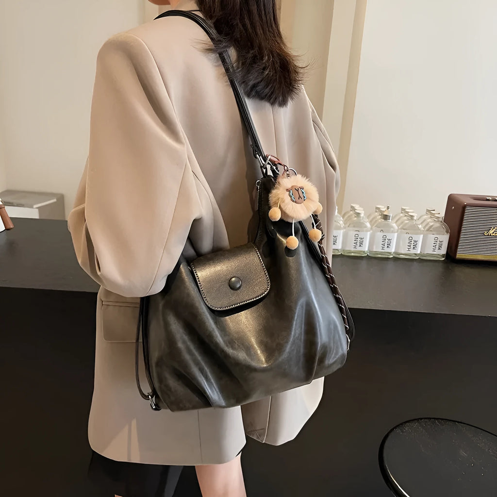 Black leather PU women's single-shoulder backpack with textured finish and horizontal square shape
