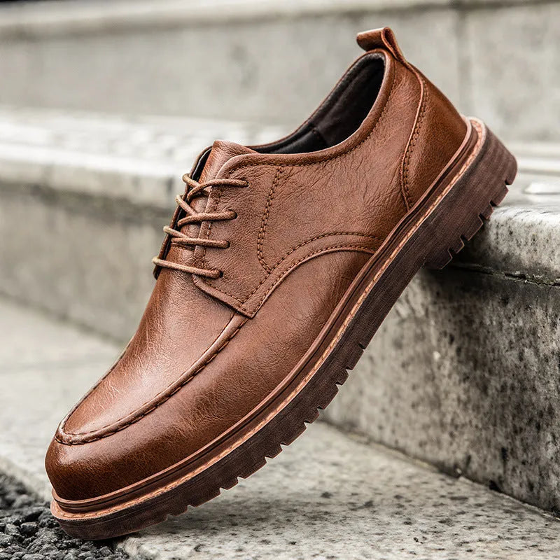 Men's black and brown casual leather shoes with a round toe and flat rubber sole.