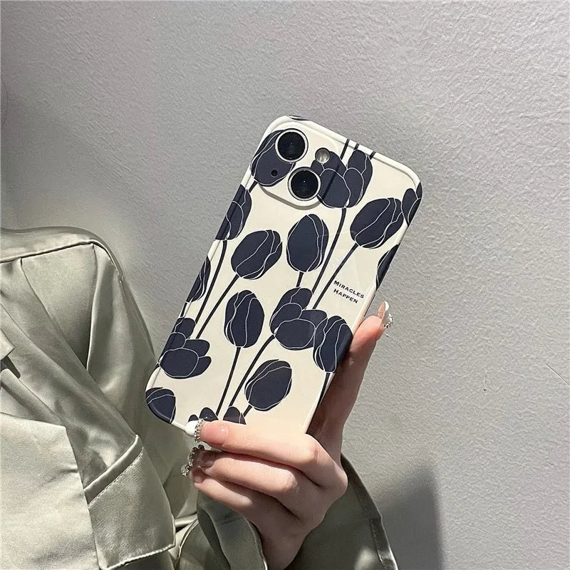 Black silicone iPhone case featuring a printed tulip flower design on the back.