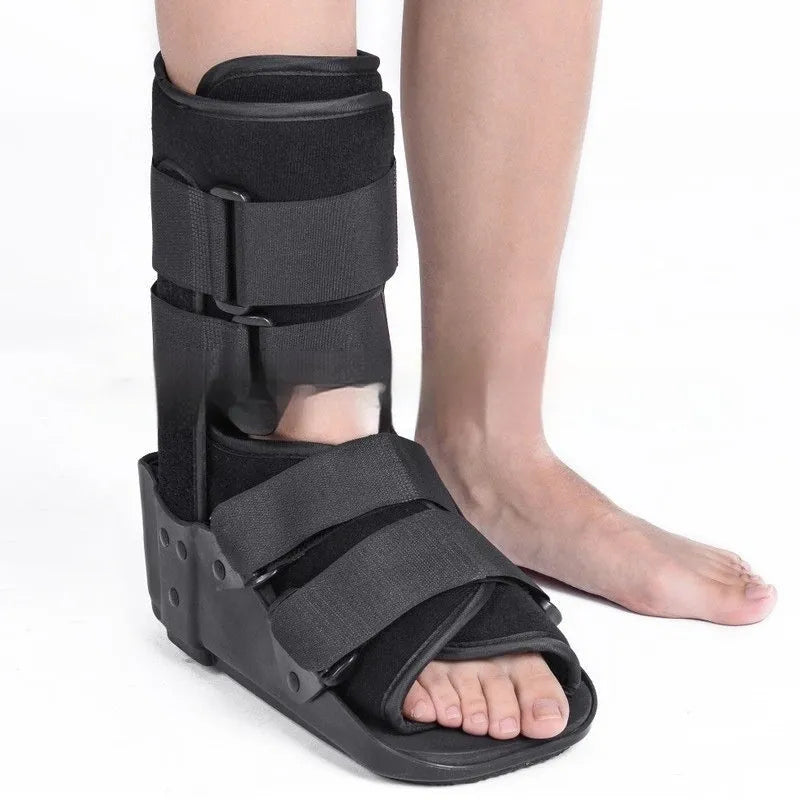A black Achilles tendon rehabilitation boot with fixed support, showing straps and structural design.
