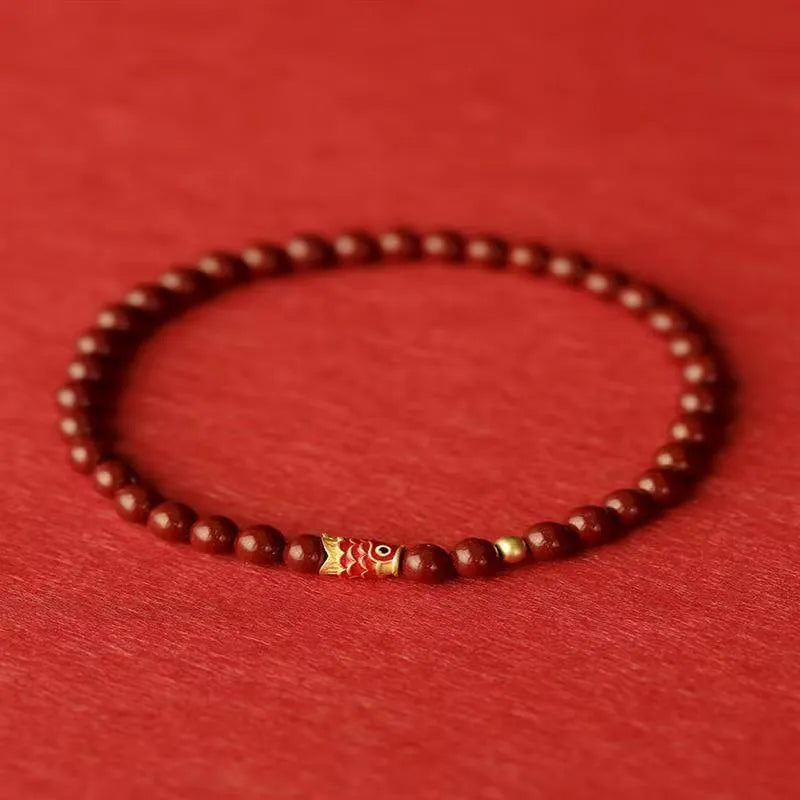 Handmade natural cinnabar bracelet with koi fish and golden ball charms in national style