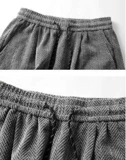 Light grey fleece-lined straight-leg trousers with a hollow-out sports design on a hanger.