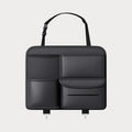 Black leather car seat back storage hanging bag with handle shown on vehicle headrest