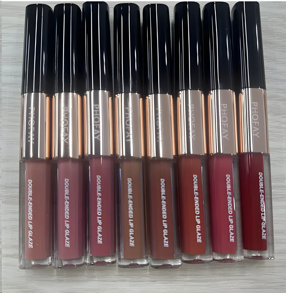 C-L021 double-head non-stick cup lip gloss in colour-coded packaging showing eight shade options