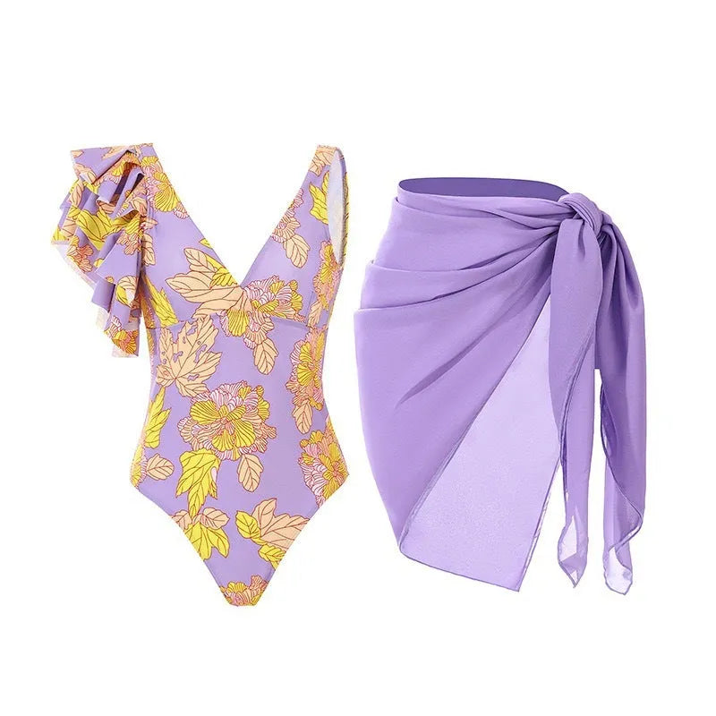 Women's solid colour one-piece swimsuit with thin spaghetti straps and a matching removable skirt.