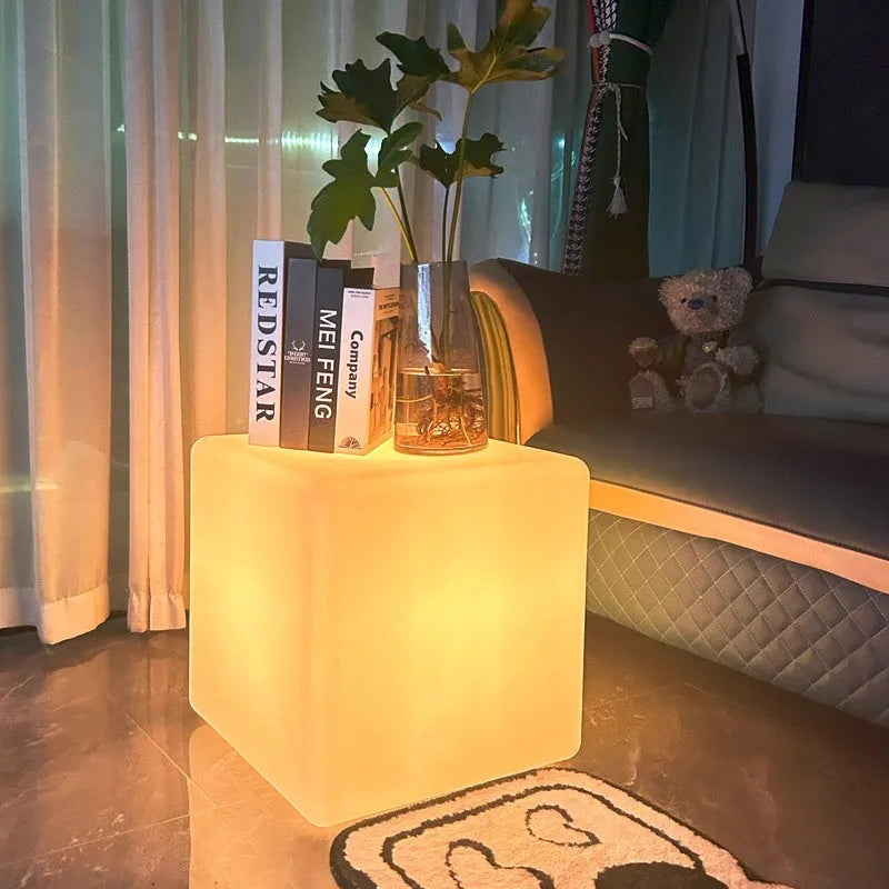 A modern square white LED cube stool light for outdoor garden use.