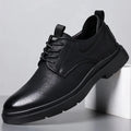 Men's black leather casual sneakers with sewing line detailing and rubber soles