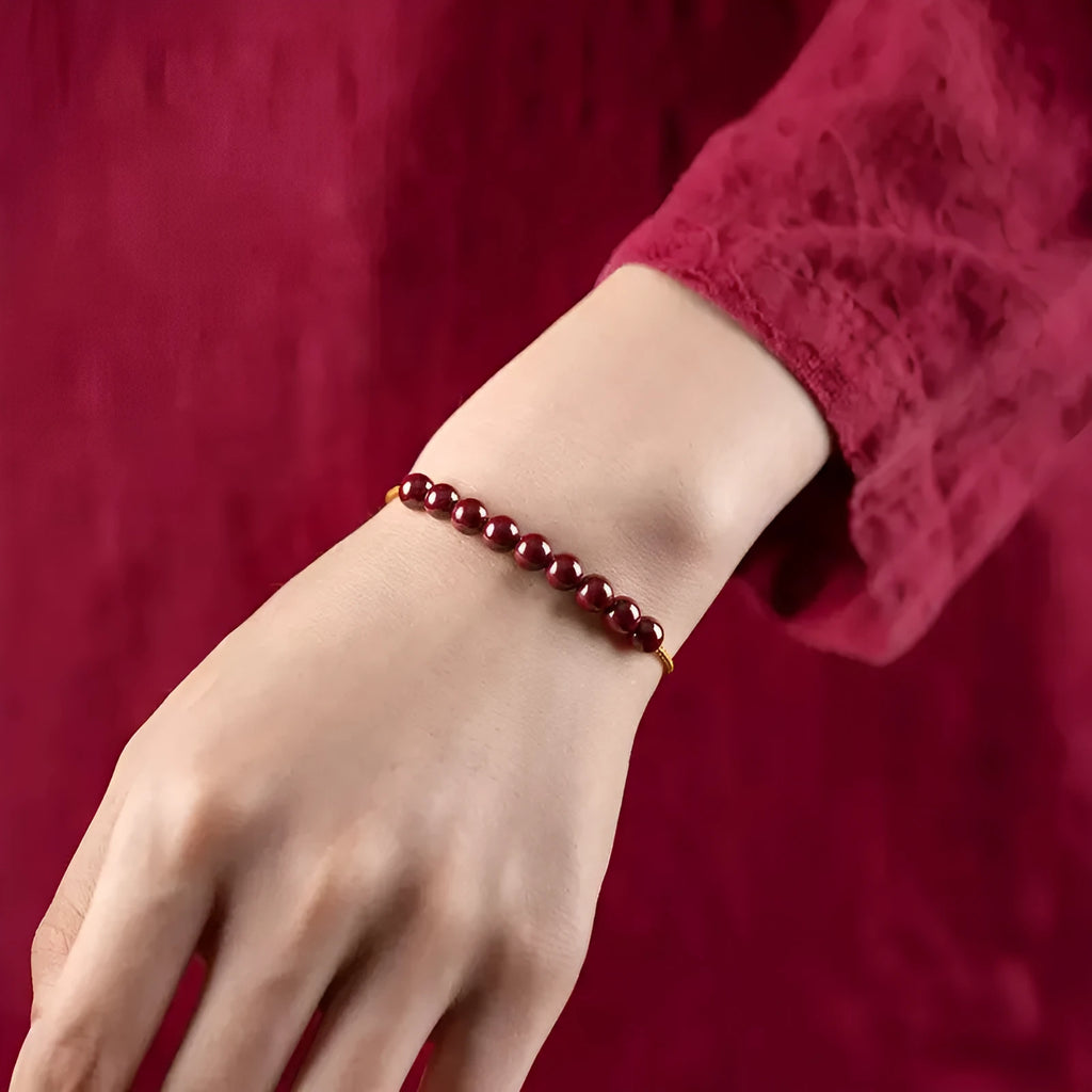 Hand-woven geometric bracelet made from raw red cinnabar ore on an adjustable cord.