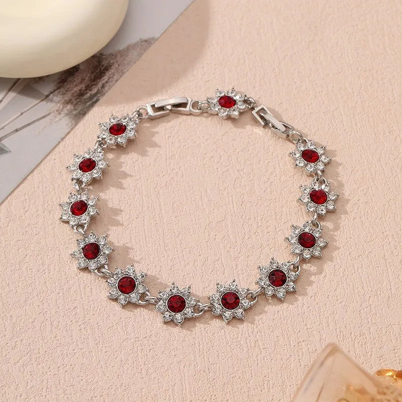 Flower-shaped bracelet with gemstone accents in gold or silver electroplated finish showing twelve colour combination options