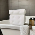 White 3D mesh bathtub pillow with seven suction cups for non-slip placement