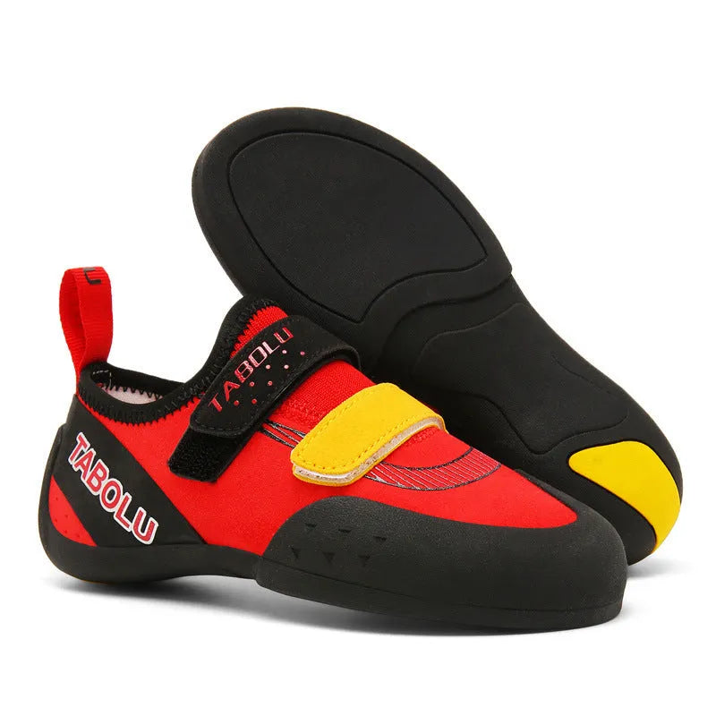 Beginner rock climbing shoes in black and red with Velcro strap and rubber sole.