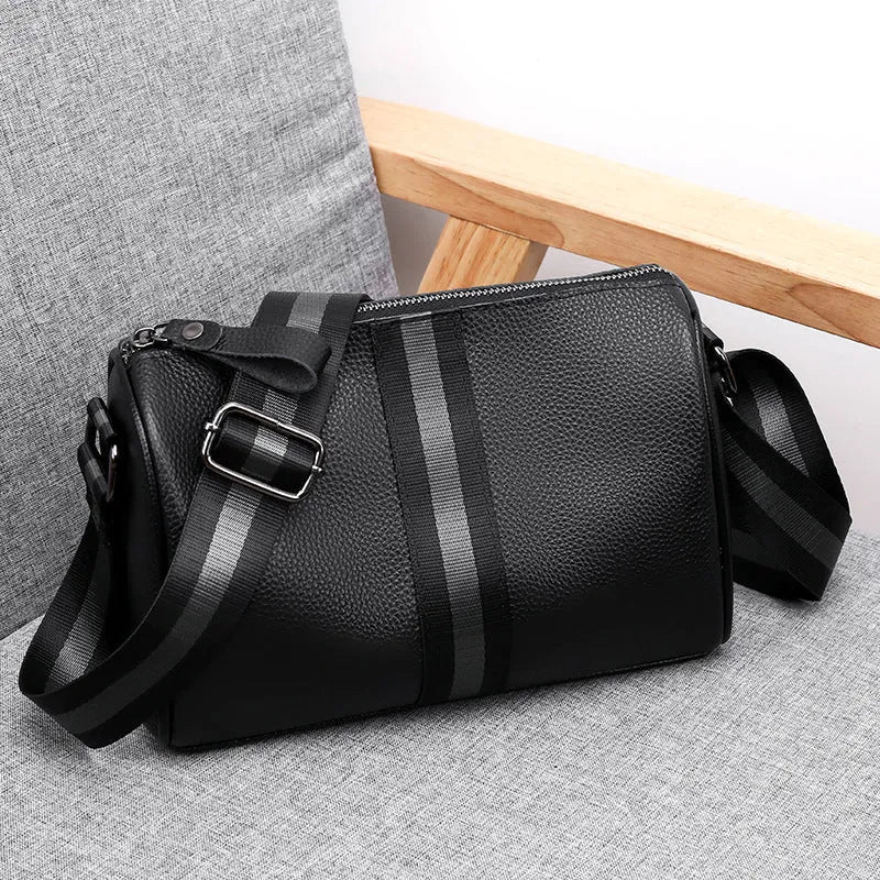Black genuine leather one-shoulder crossbody bag showing front view and adjustable strap.