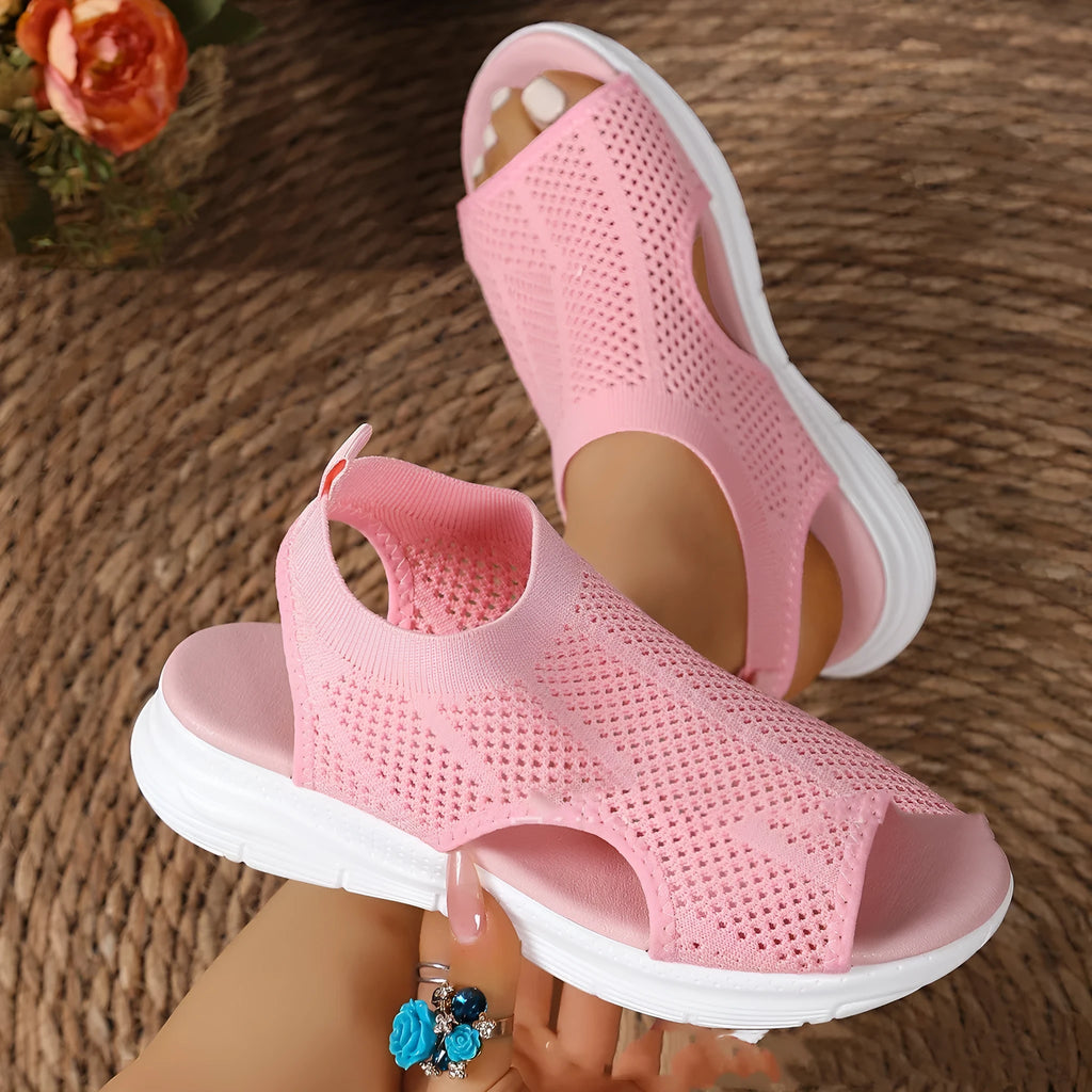 Women's platform sports sandals in black, milky white, and pink on a flat head design with a rubber sole.