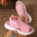 Women's platform sports sandals in black, milky white, and pink on a flat head design with a rubber sole.
