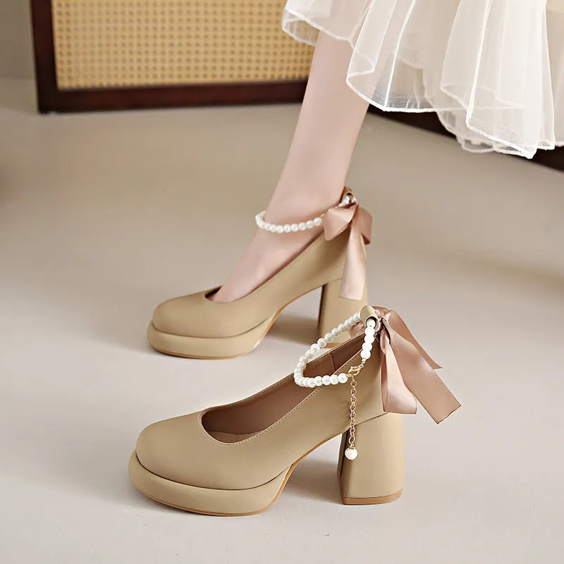 Beige women's Mary Jane shoes with chunky heel and ankle strap buckle on a white background
