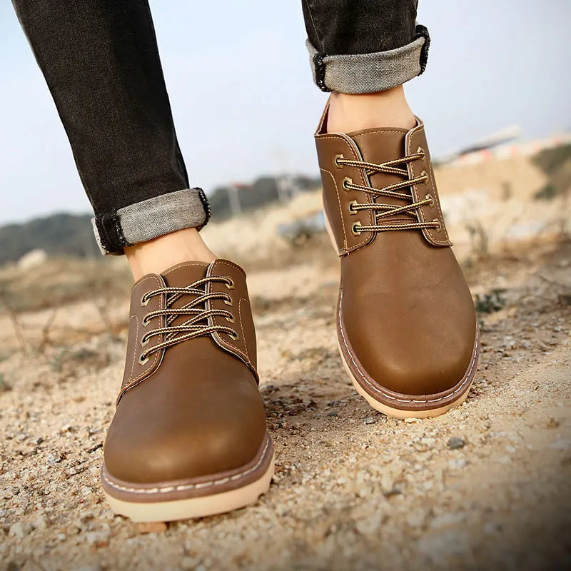 Men's black leather mid-top ankle boots with rubber soles showing waterproof British tide style